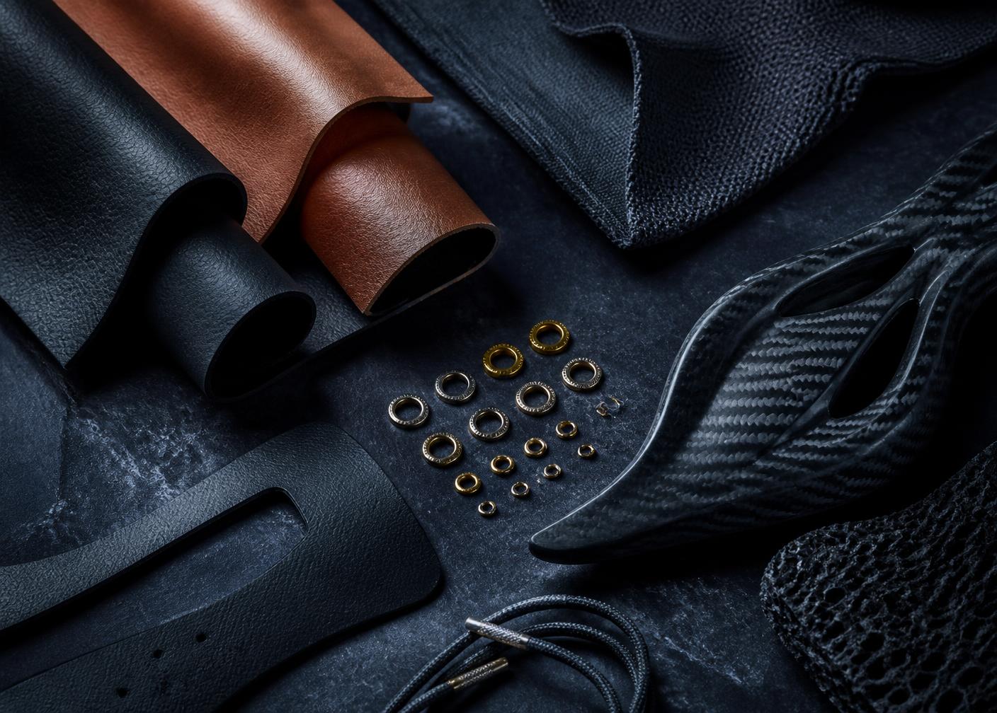 Premium footwear materials: leather, technical knit and gold eyelets